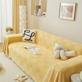 Oregelbundet rutigt randigt puffade sammetsoffatäcke Carvallo