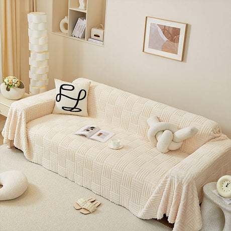 Oregelbundet rutigt randigt puffade sammetsoffatäcke Carvallo